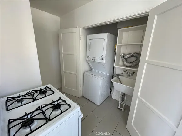 a utility room with sink dryer and washer