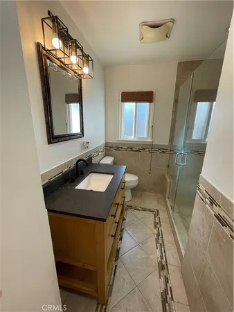 an empty room with wooden floor fan and window