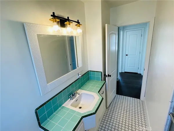 a bathroom with a sink a toilet and mirror