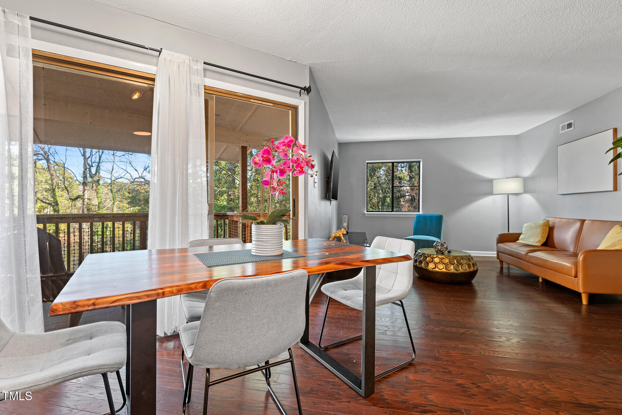 a dining room with furniture and wooden floor