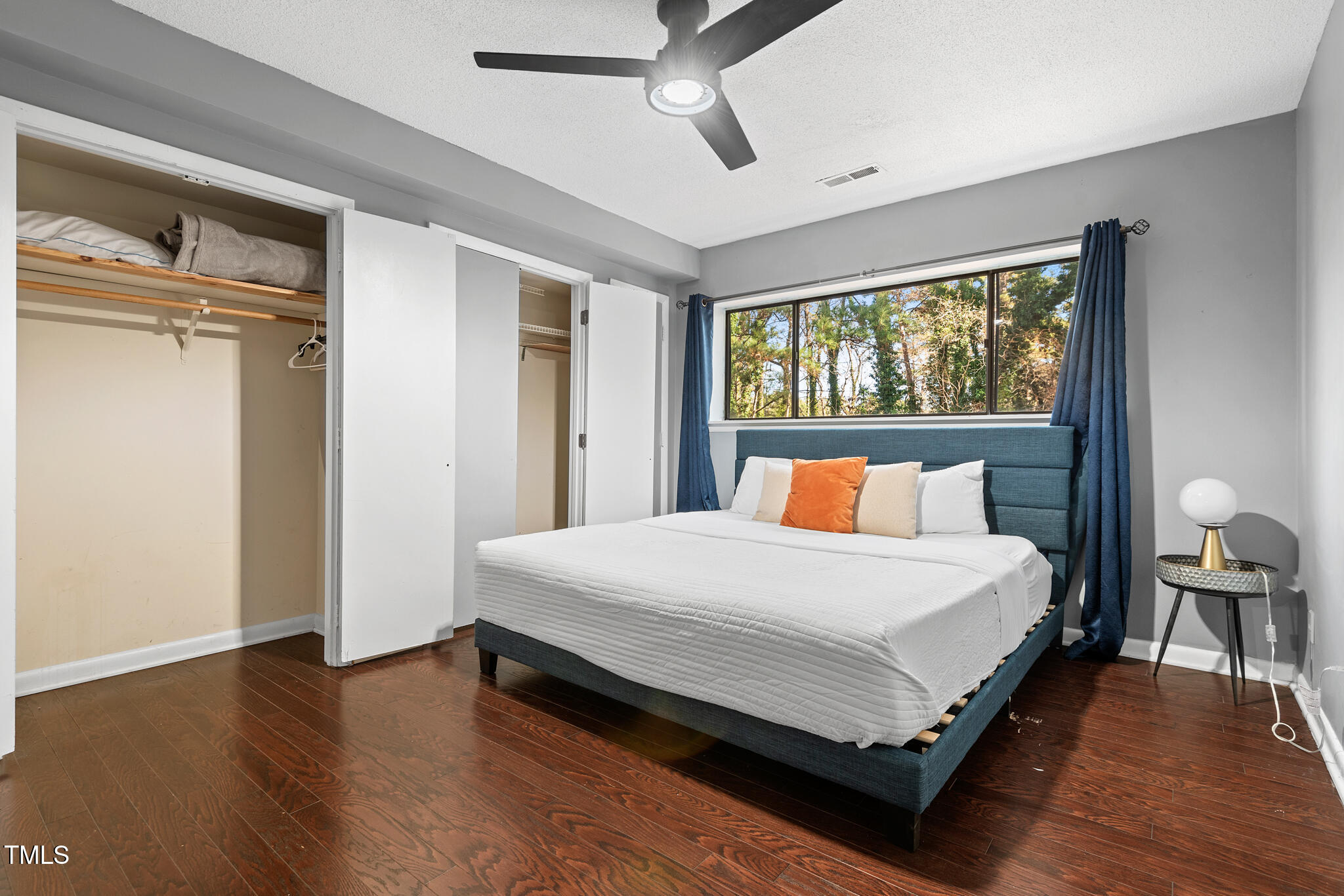5084 Flint Ridge Place Raleigh, NC 27609 - Photo 11 of 23 a large bed sitting in a bedroom next to a window and a chandelier
