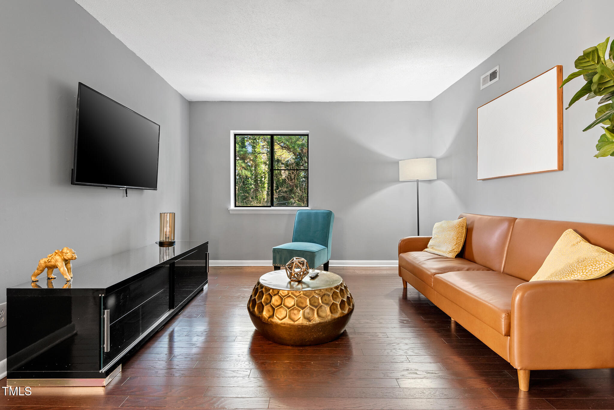 5084 Flint Ridge Place Raleigh, NC 27609 - Photo 2 of 23 a living room with furniture and a flat screen tv
