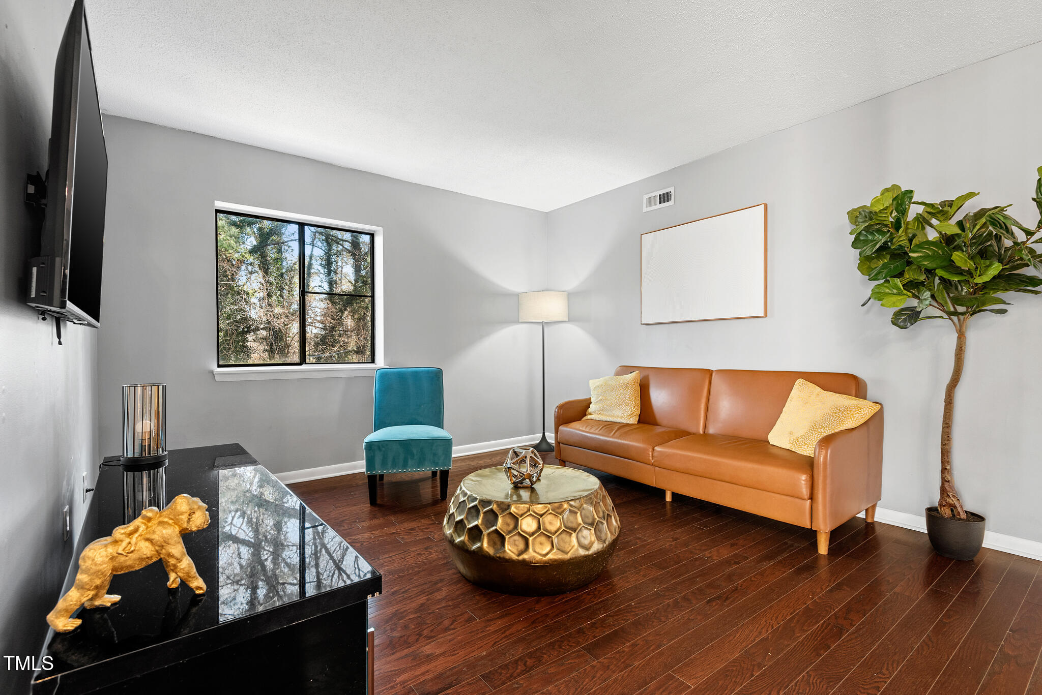 5084 Flint Ridge Place Raleigh, NC 27609 - Photo 3 of 23 a living room with furniture and a wooden floor