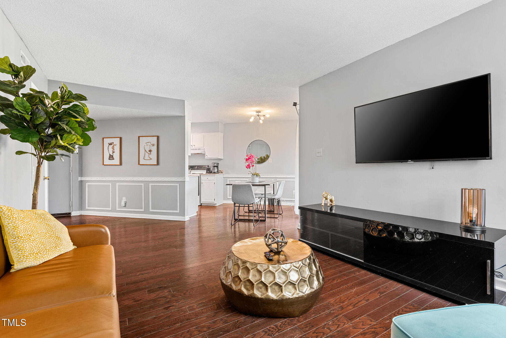5084 Flint Ridge Place Raleigh, NC 27609 - Photo 4 of 23 a living room with furniture and a flat screen tv