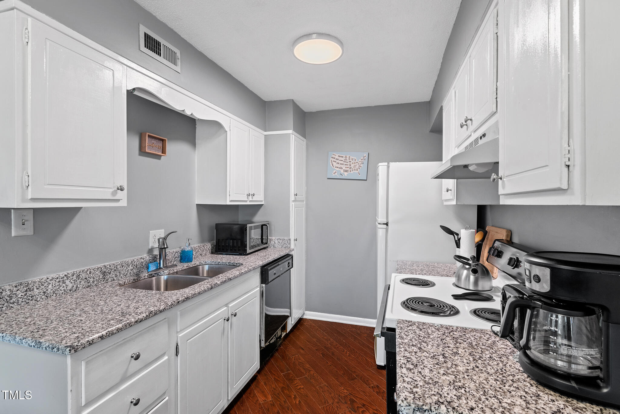 5084 Flint Ridge Place Raleigh, NC 27609 - Photo 8 of 23 a kitchen with granite countertop a sink stove and cabinets