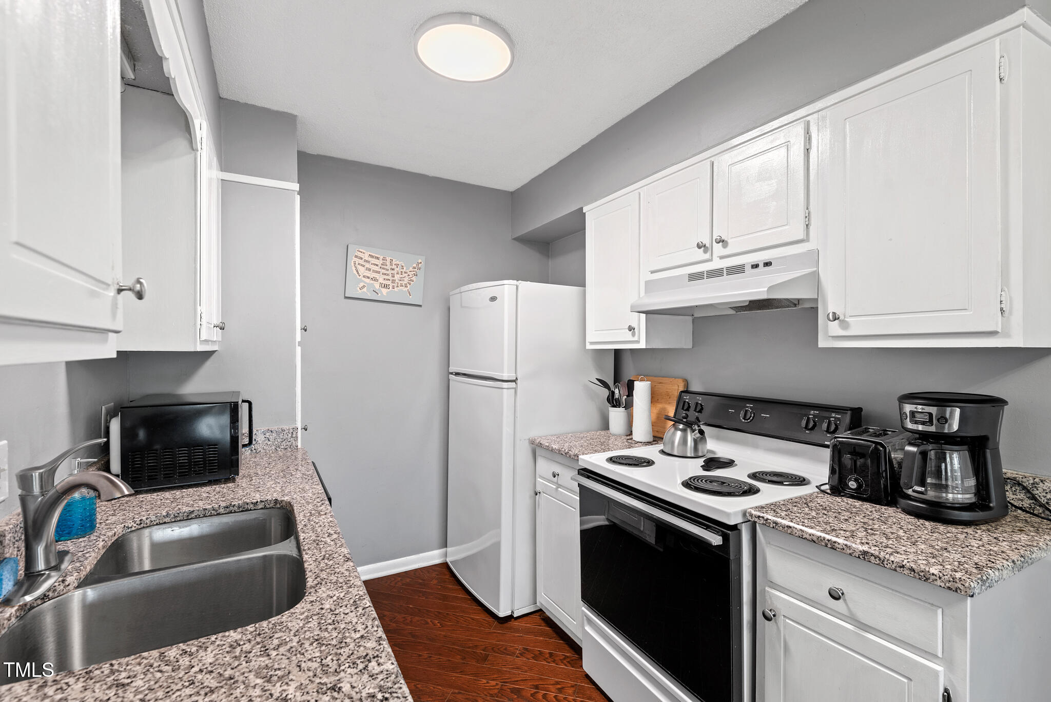 5084 Flint Ridge Place Raleigh, NC 27609 - Photo 9 of 23 a kitchen with stainless steel appliances granite countertop a stove a refrigerator and a sink with cabinets