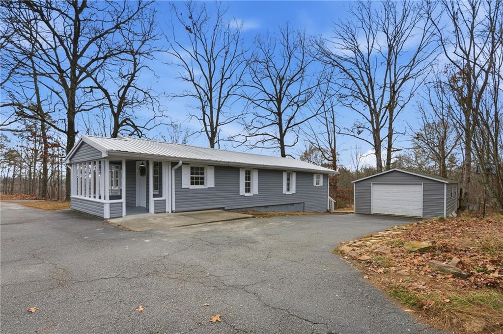 1780 Wynn Lake Road Alto, GA 30510 - Photo 2 of 30 a front view of a house with a garden and trees
