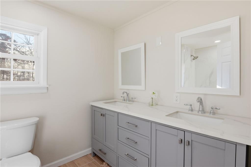 1780 Wynn Lake Road Alto, GA 30510 - Photo 22 of 30 a bathroom with a toilet sink and mirror