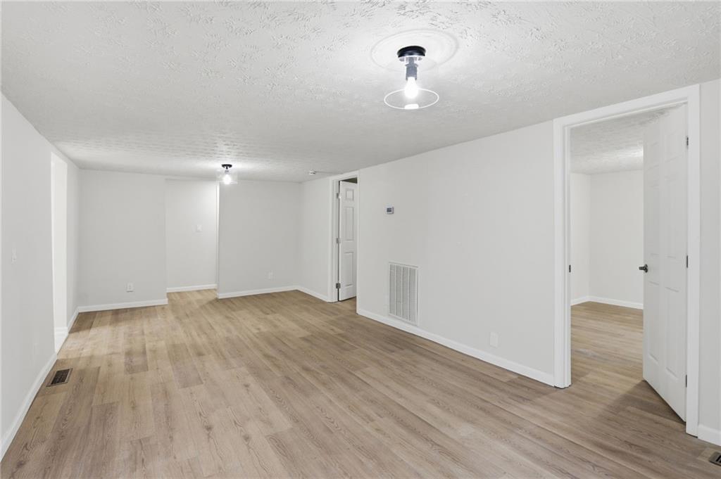 1780 Wynn Lake Road Alto, GA 30510 - Photo 6 of 30 a view of empty room with wooden floor