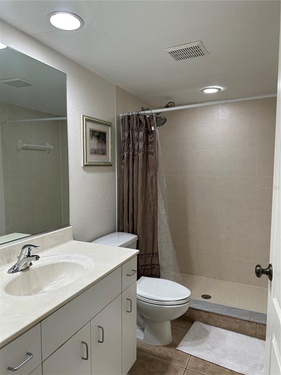 8050 Memory Lane, Unit 101 Rotonda West, FL 33947 - Photo 12 of 16 a bathroom with a sink a toilet and shower