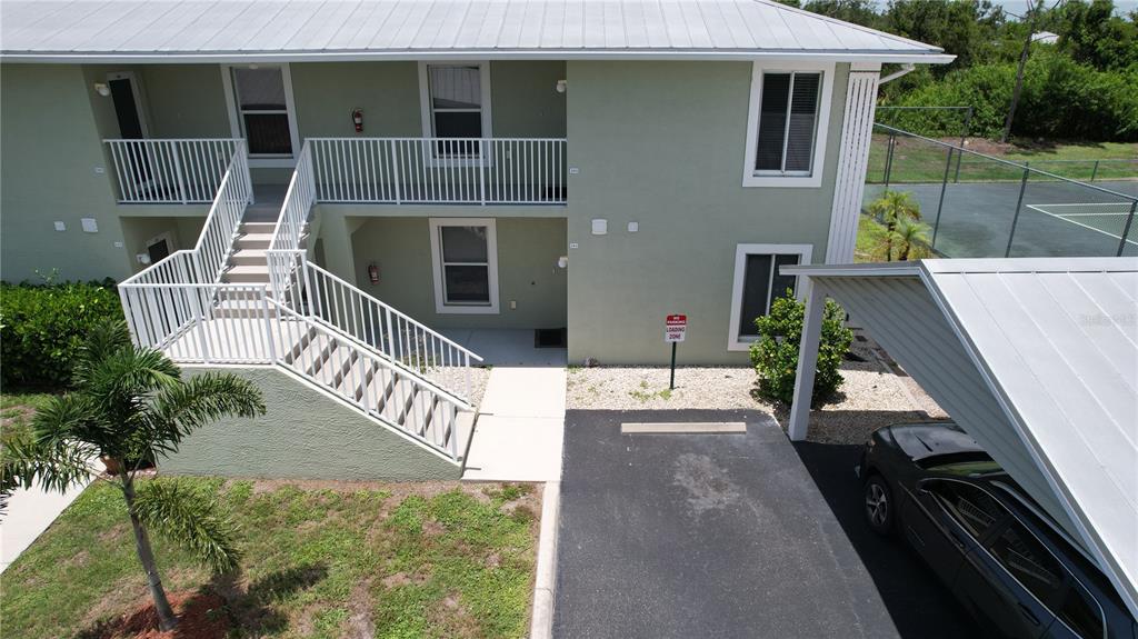 8050 Memory Lane, Unit 101 Rotonda West, FL 33947 - Photo 2 of 16 a view of a house with backyard and deck