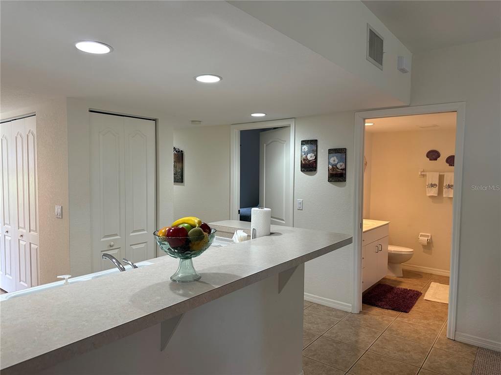 8050 Memory Lane, Unit 101 Rotonda West, FL 33947 - Photo 6 of 16 a bathroom with a sink a toilet and shower curtain