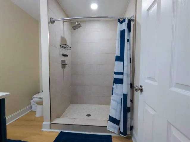 a bathroom with a shower and toilet