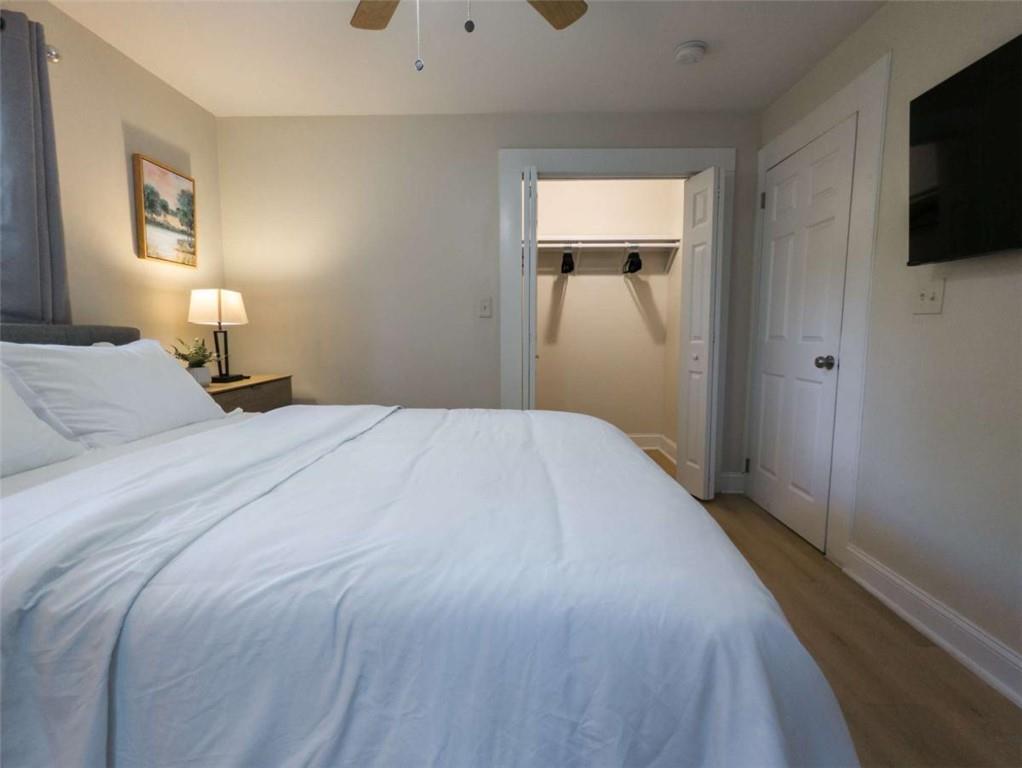 6557 Woodrow Road Lithonia, GA 30038 - Photo 13 of 17 a bedroom with a bed and a flat tv screen on dresser