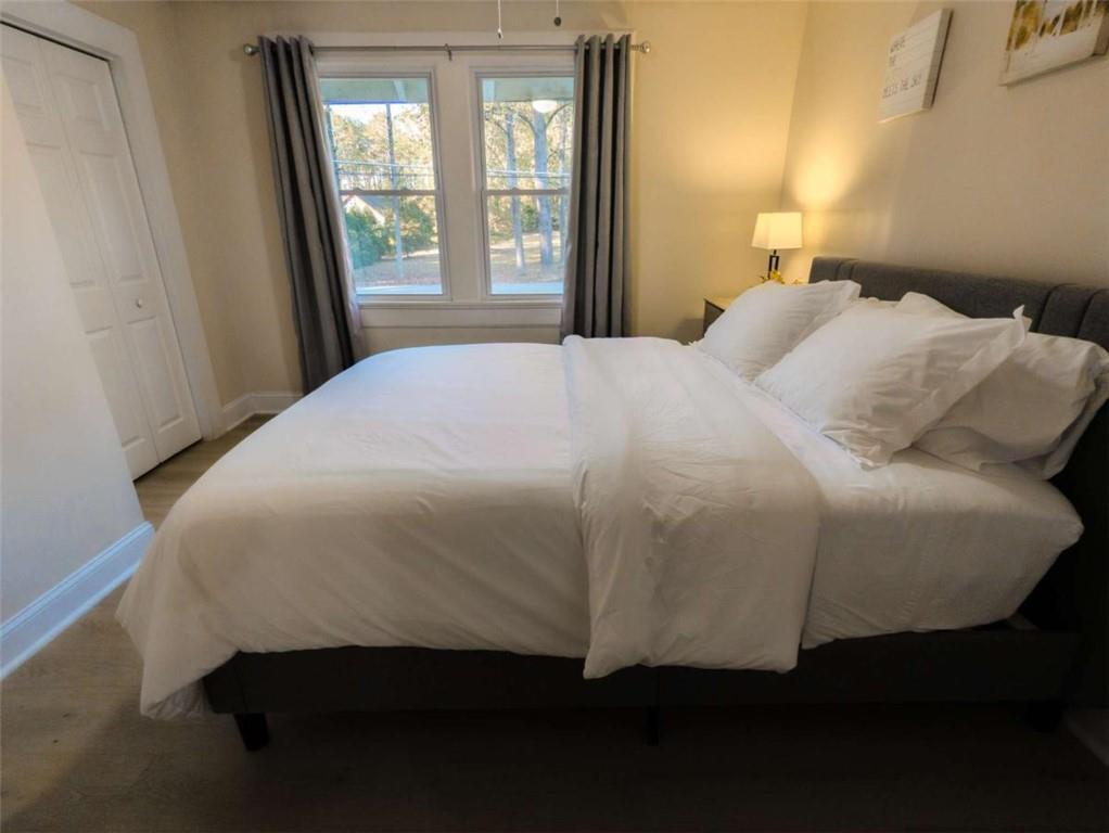 6557 Woodrow Road Lithonia, GA 30038 - Photo 14 of 17 a bed sitting in a bedroom next to a window