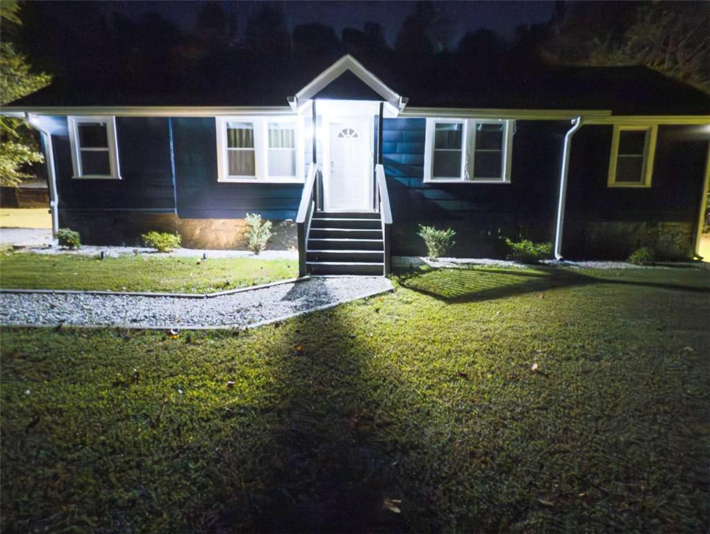 6557 Woodrow Road Lithonia, GA 30038 - Photo 17 of 17 a front view of a house with garden