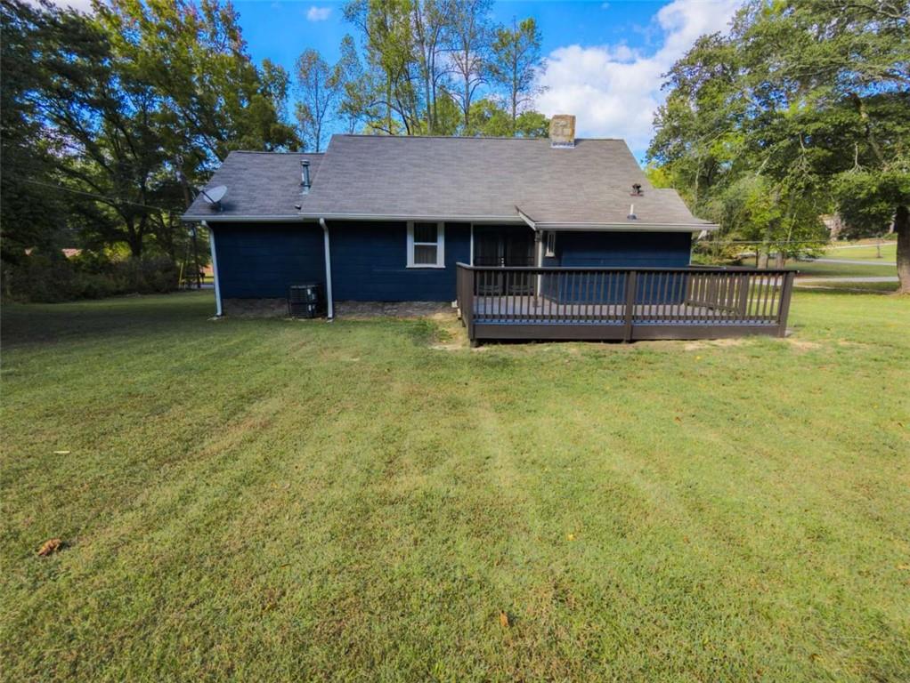 6557 Woodrow Road Lithonia, GA 30038 - Photo 2 of 17 a view of a house with a yard and tree