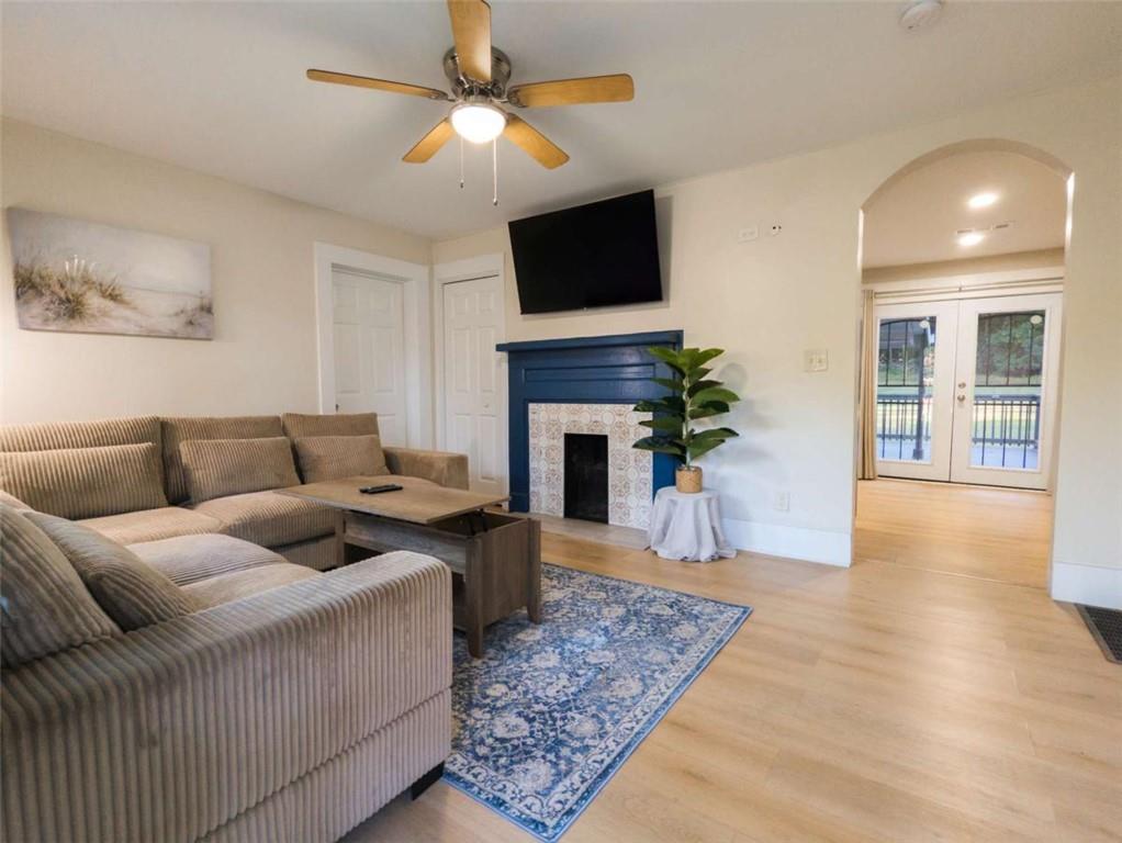 6557 Woodrow Road Lithonia, GA 30038 - Photo 4 of 17 a living room with furniture a fireplace and a flat screen tv