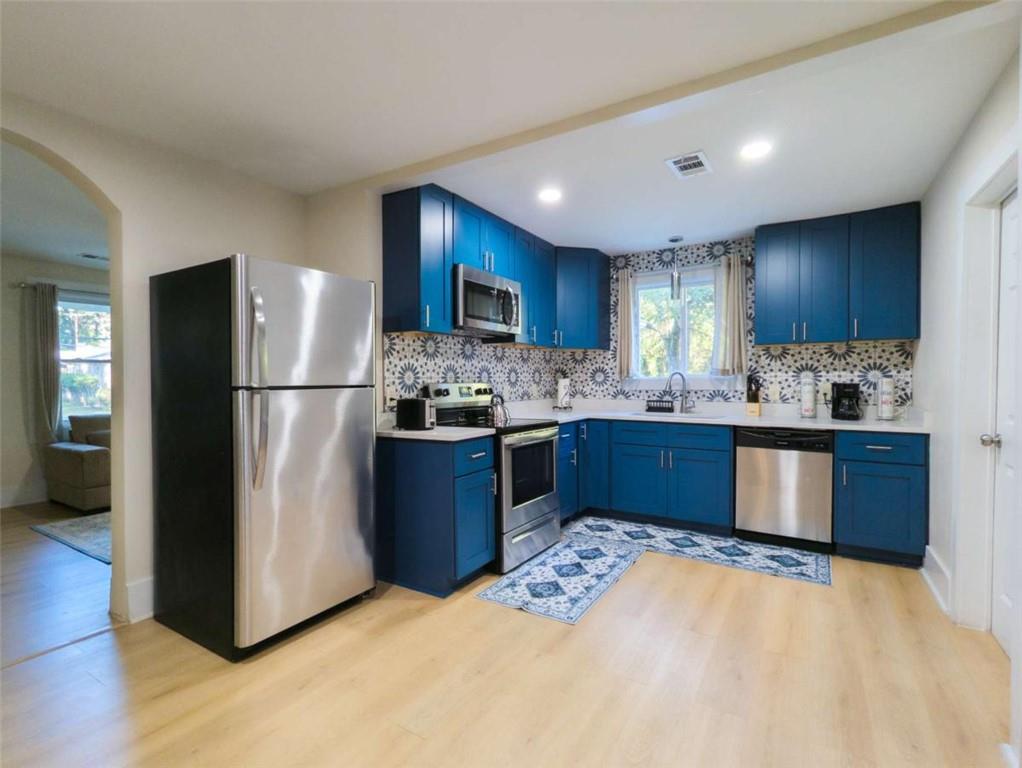6557 Woodrow Road Lithonia, GA 30038 - Photo 7 of 17 a kitchen with a refrigerator sink and cabinets