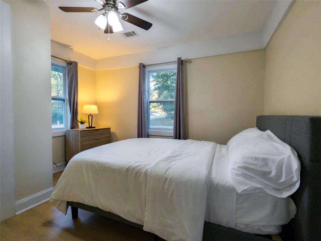 6557 Woodrow Road Lithonia, GA 30038 - Photo 9 of 17 a bedroom with a bed and wooden floor