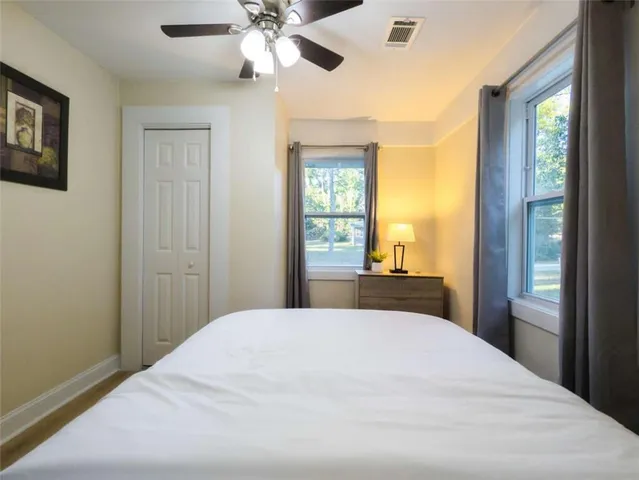 a bedroom with a large bed and a chandelier