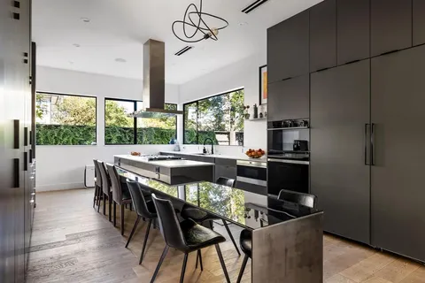 a dining room with furniture a chandelier and wooden floor