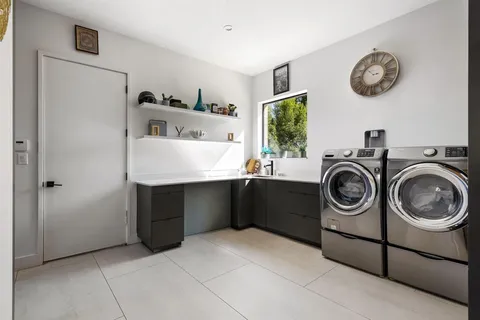 a utility room with sink dryer and washer