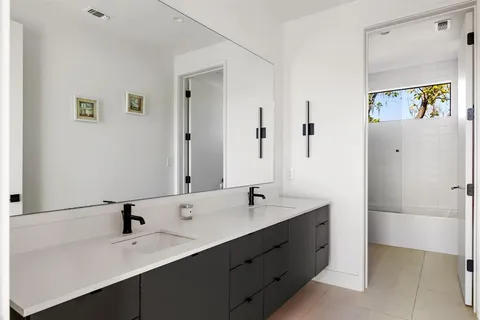 a bathroom with a double vanity sink and mirror