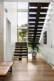 a view of entryway and hall with wooden floor
