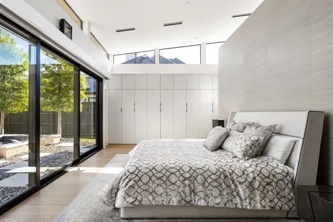 a bedroom with a large bed and a large window