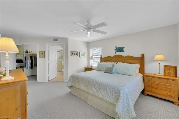 a bedroom with a bed and ceiling fan