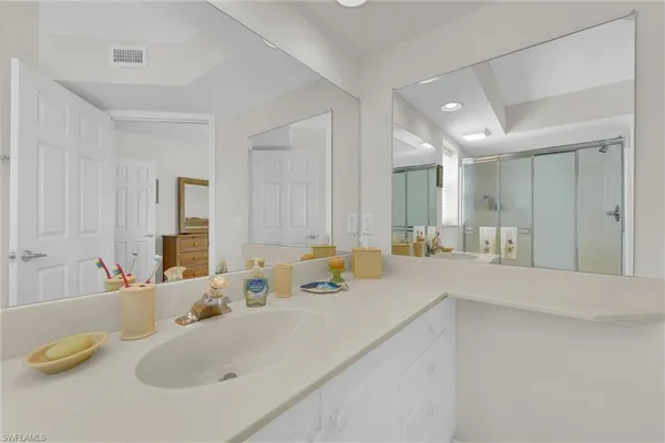 a bathroom with a sink vanity and a mirror