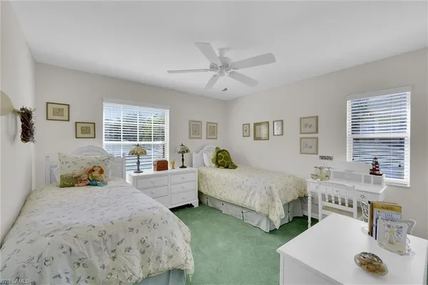 a spacious bedroom with two beds and large window