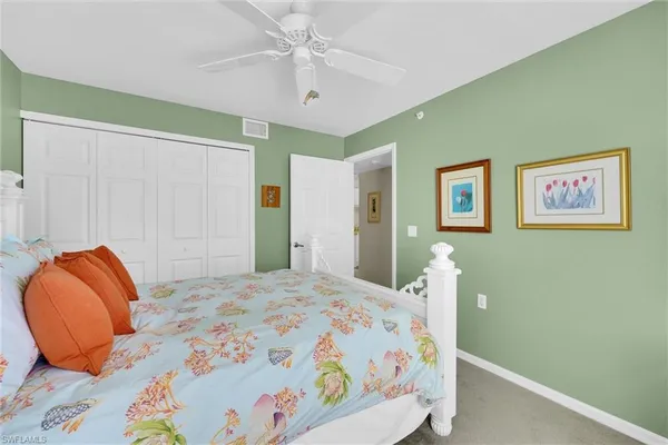 a bedroom with a bed and a lamp