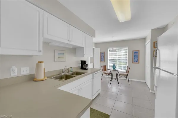 a kitchen that has a lot of cabinets in it and appliances