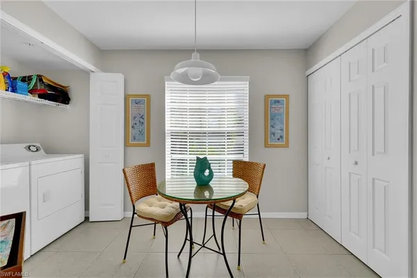 a dining room with furniture and window
