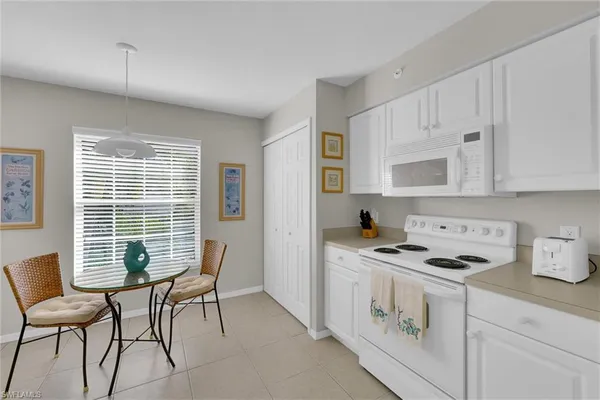 a kitchen with stainless steel appliances a stove a sink cabinets and a window