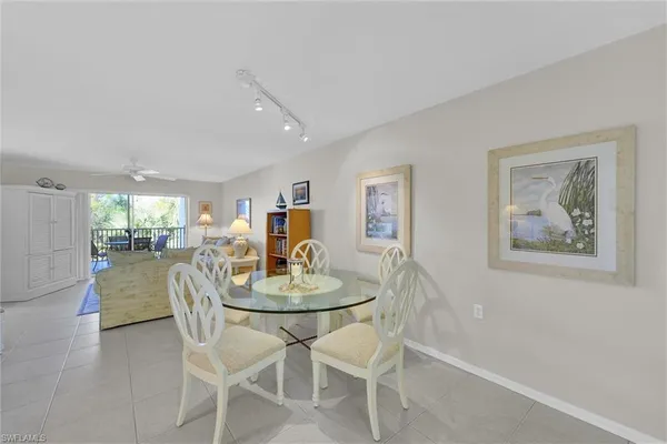 a dining room with furniture and window
