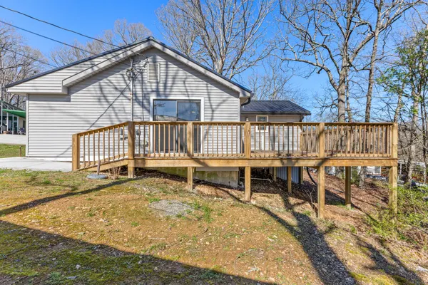 a view of a house with a wooden deck