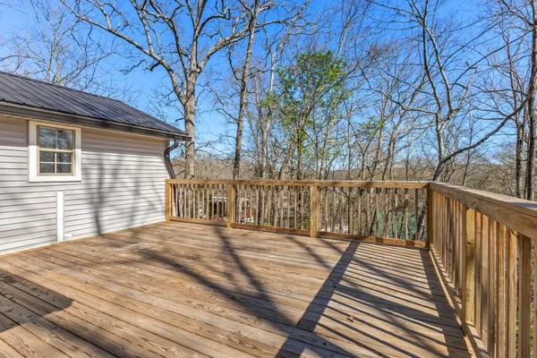 a balcony with wooden floor and fence