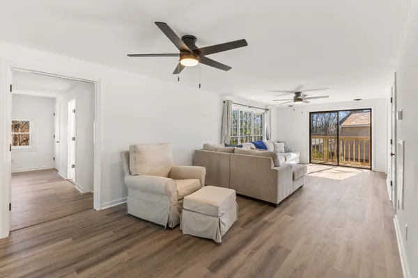 a living room with furniture and a wooden floor