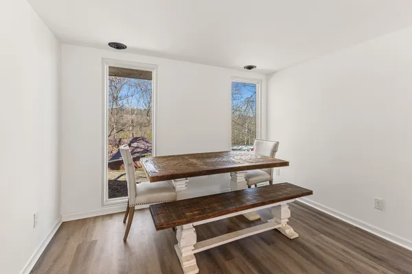 a bench sitting in a room next to a window