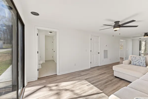 a living room with furniture and a ceiling fan