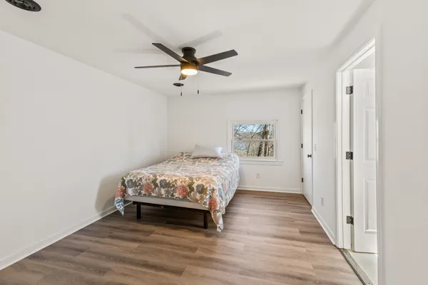 a bedroom with a bed and a chandelier
