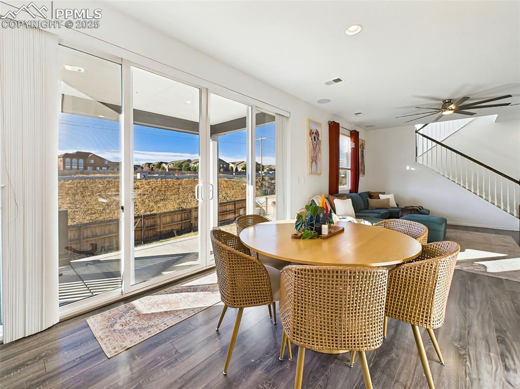 6272 Anders Ridge Lane Colorado Springs, CO 80927 - Photo 13 of 50 Enjoy easy indoor-outdoor flow from the central dining space, ideal for entertaining or everyday meals with a view.