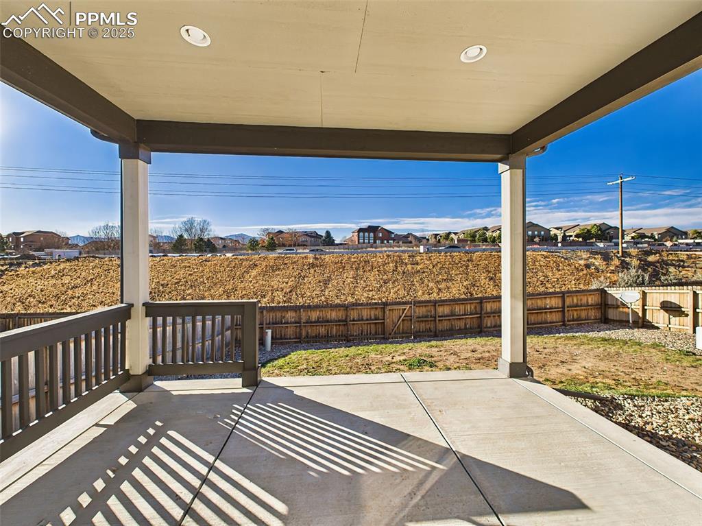 6272 Anders Ridge Lane Colorado Springs, CO 80927 - Photo 15 of 50 Covered rear patio offers a shaded outdoor living area with Pikes Peak views—perfect for outdoor dining or lounging.