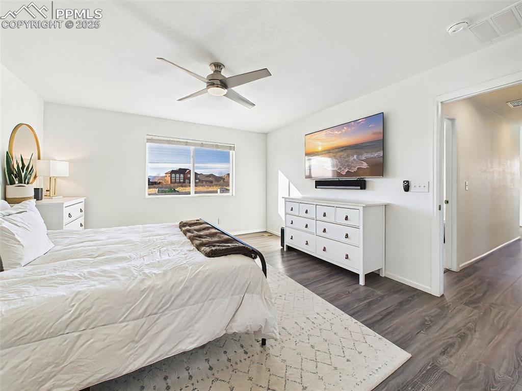 6272 Anders Ridge Lane Colorado Springs, CO 80927 - Photo 28 of 50 Another look at the spacious primary bedroom, complete with neutral tones and natural light.