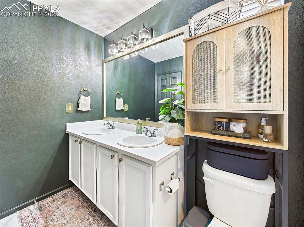 6272 Anders Ridge Lane Colorado Springs, CO 80927 - Photo 39 of 50 Second angle reveals sleek storage and gold-accented fixtures — a unique blend of functionality and aesthetic appeal.