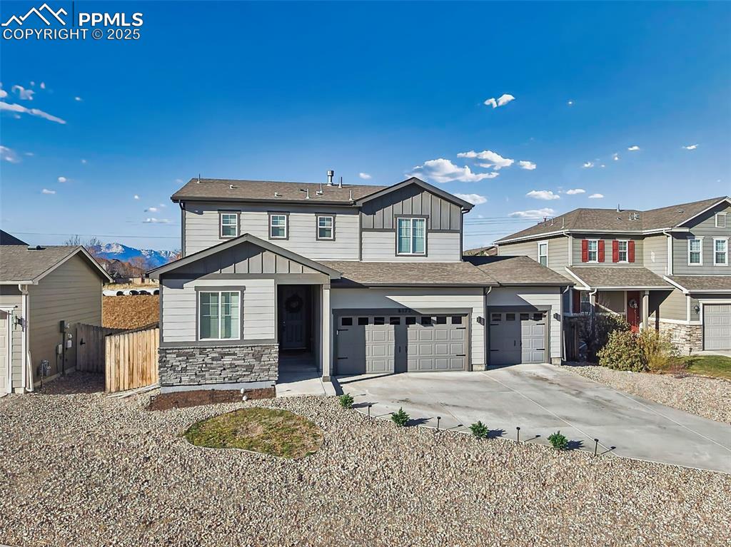 6272 Anders Ridge Lane Colorado Springs, CO 80927 - Photo 42 of 50 Welcoming curb appeal with upgraded garage lighting, covered entry, and thoughtfully placed windows to maximize natural light.