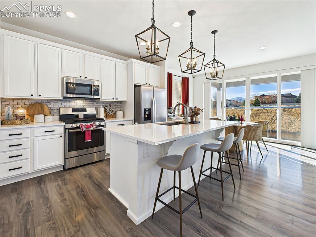 6272 Anders Ridge Lane Colorado Springs, CO 80927 - Photo 6 of 50 Extended cabinetry and generous countertop space highlight the thoughtful design, with easy access to the dining area and outdoor patio.